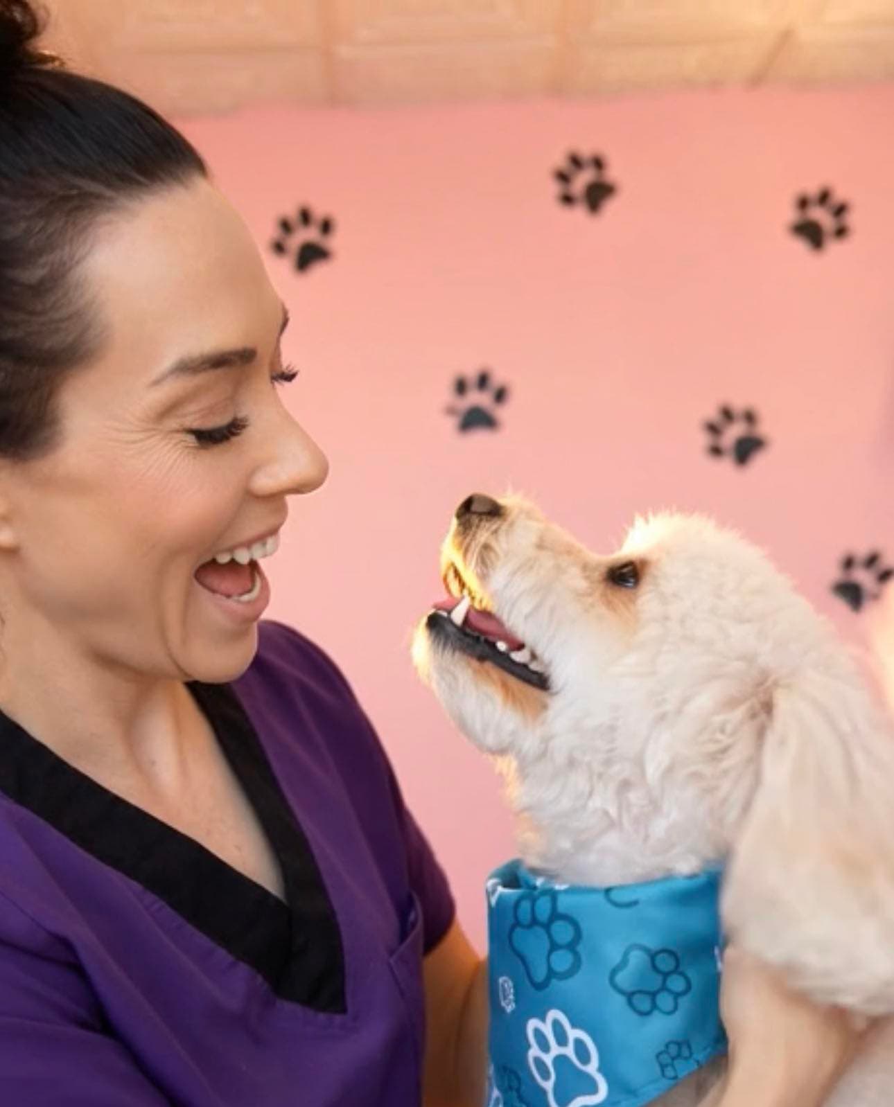 LilaJean laughing with a small white dog at The Paw Queen grooming salon in Boulder City, NV